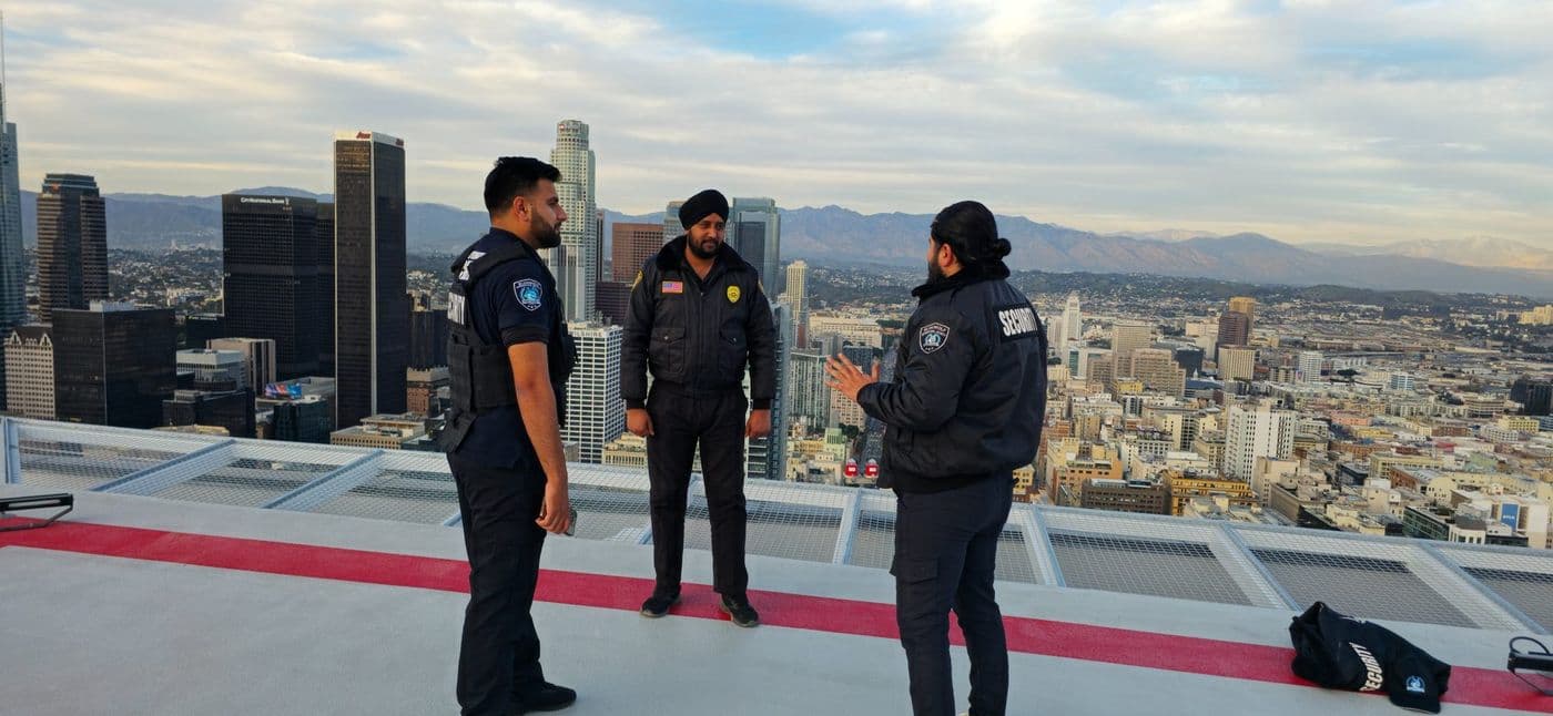 Naji briefing his security team on a rooftop overlooking Los Angeles